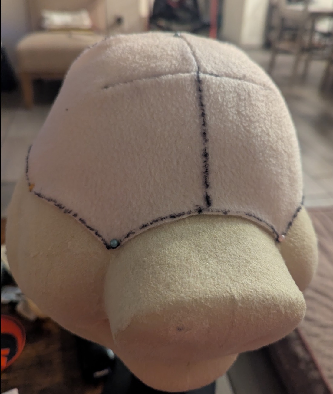 Fabric pattern test pinned on a plush pig head